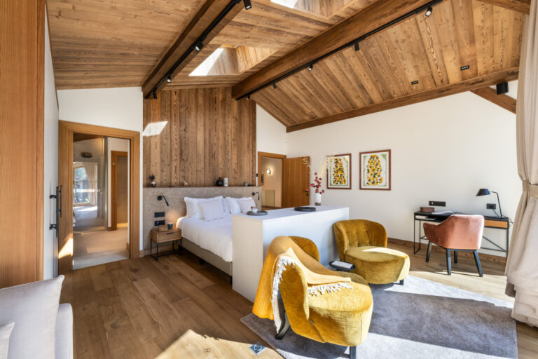 Spacious modern bedroom with wooden accents.